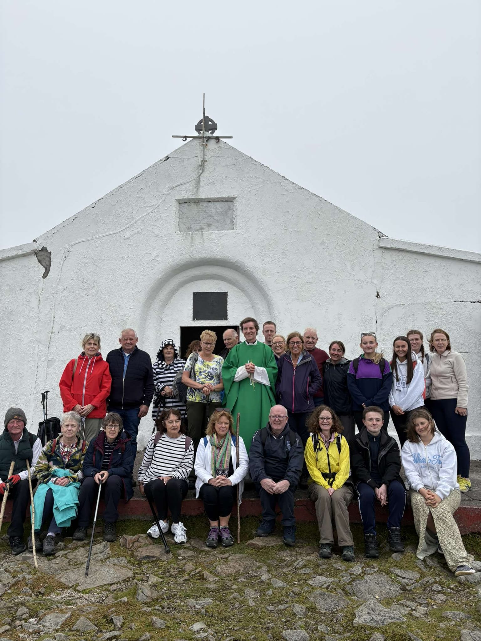 Pilgrims with Fr Roland Colhoun on the summit of Croagh Patrick after Mass